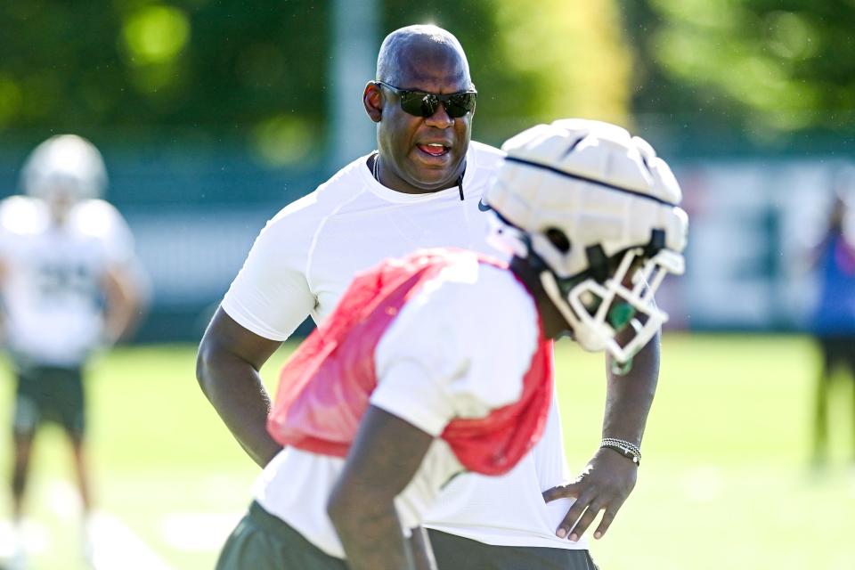 Michigan State head coach Mel Tucker talks with cornerback Charles Brantley during football practice on Thursday, Aug. 11, 2022, in East Lansing.