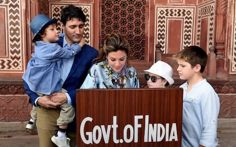 Prime Minister of Canada Justin Trudeau, his wife Sophie Gregoire and their children write on the visitors book during their visit to Taj Mahal - Credit:  MONEY SHARMA/AFP