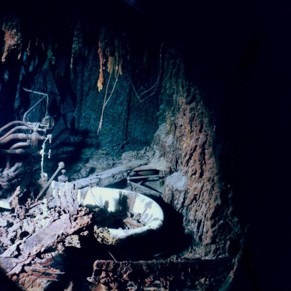 A view of the bathtub in Capt. Smiths bathroom. Rusticles are observed growing over most of the pipes and fixtures in the room (NOAA)