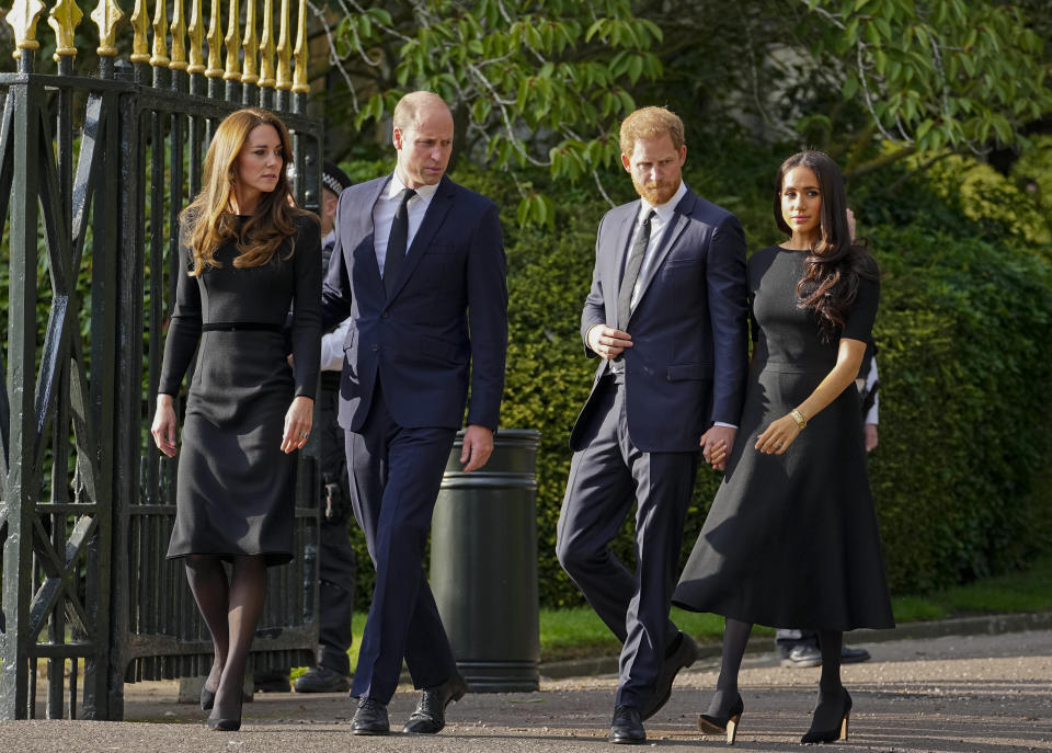 FILE - Britain's Prince William, second left, Kate, Princess of Wales, left, Britain's Prince Harry, second right, and Meghan, Duchess of Sussex view the floral tributes for the late Queen Elizabeth II outside Windsor Castle, in Windsor, England on Sept. 10, 2022. Prince Harry flew more than 5,000 miles to see his father after King Charles III was diagnosed with cancer. But he did not see his estranged brother, William, during a visit that lasted scarcely 24 hours. William, meanwhile, returned to public duties for the first time since his wife, Kate, was admitted to a London hospital Jan. 16 for abdominal surgery. (AP Photo/Martin Meissner, File)