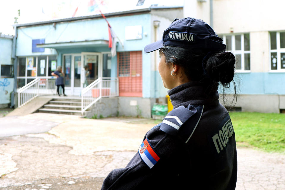 An officer keeps watch at a school in Belgrade, Serbia, May 8, 2023, after a teenage boy opened fire in a school, killing eight students and a security guard. Police officers were assigned in pairs to some 1,800 schools across Serbia. / Credit: Sasa Dordevic/Anadolu Agency/Getty