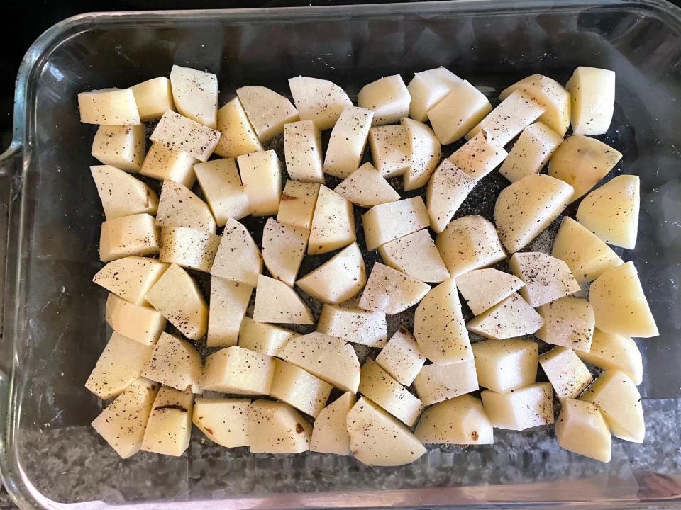 Seasoning potatoes for Dad's Greek Lemon Potatoes