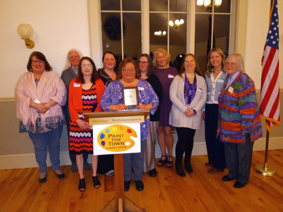 Wayne Library Alliance (WLA) received the Not-for-Profit Award on April 25, 2024, at Downtown Hawley Partnership's annual dinner. All seven libraries were represented. From left are Lynn Scramuzza (Hamlin Library), Jane Bollinger (Bethany Library), Amy Payne (Northern Wayne Library), Jenny Snyder (Pleasant Mount Library), Mikki Uzupes (WLA/Wayne County Public Library) holding the plaque, Amy Keane (Hawley Library), Tracy L. Schwarz (WLA/Wayne County Public Library, Christine Piazzi (Newfoundland Library), Amanda Schmalzle (Hawley Library) and Elaine Herzog (DHP president).