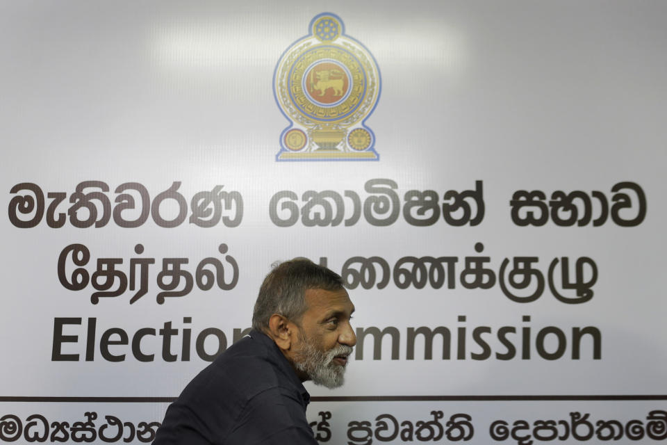 Sri Lanka's elections chief Mahinda Deshapriya arrives for a press conference in Colombo, Sri Lanka, Wednesday, Oct. 16, 2019. Deshapriya says he has asked for an explanation from the defense ministry on why the army commander features in an advertisement promoting a candidate for next month's presidential election. The advertisement, which appeared in a newspaper last weekend, had comments made by Lt. Gen. Shavendra Silva, the current army chief, in 2009 praising presidential candidate Gotabaya Rajapaksa for his role in ending the country's long civil war. (AP Photo/Eranga Jayawardena)