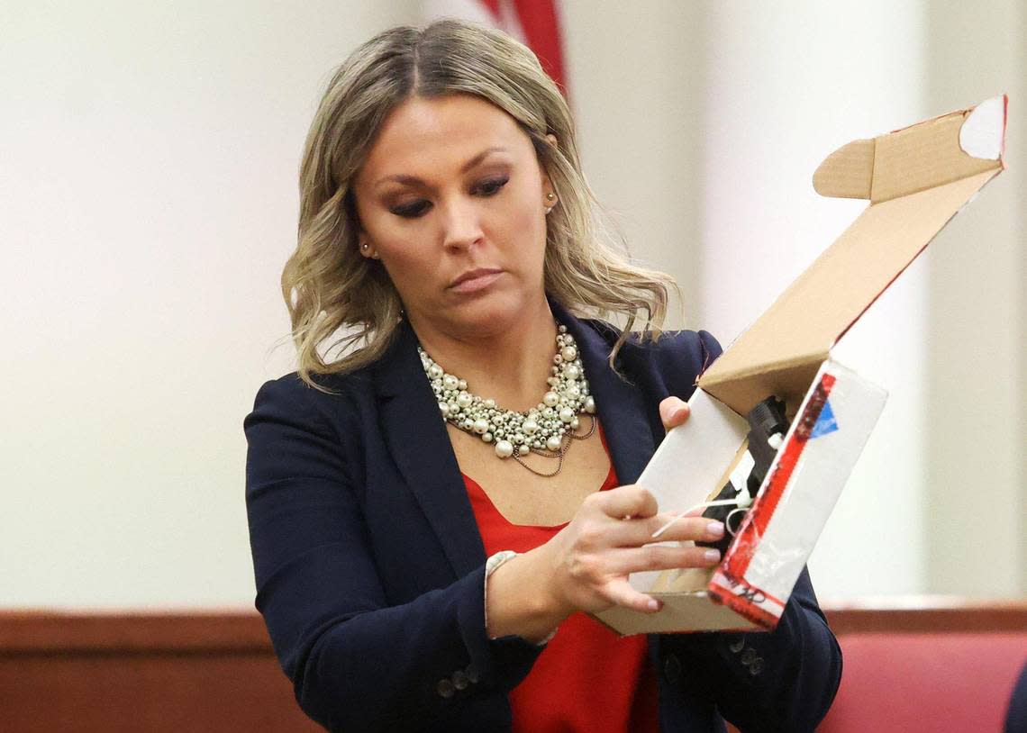 Assistant Criminal District Attorney Ashlea Deener holds up the gun found inside the home of Atatiana Jefferson during the third day of trial on Wednesday, December 7, 2022. Former Fort Worth police officer Aaron Dean fatally shot Jefferson in 2019 through a window at her home.
