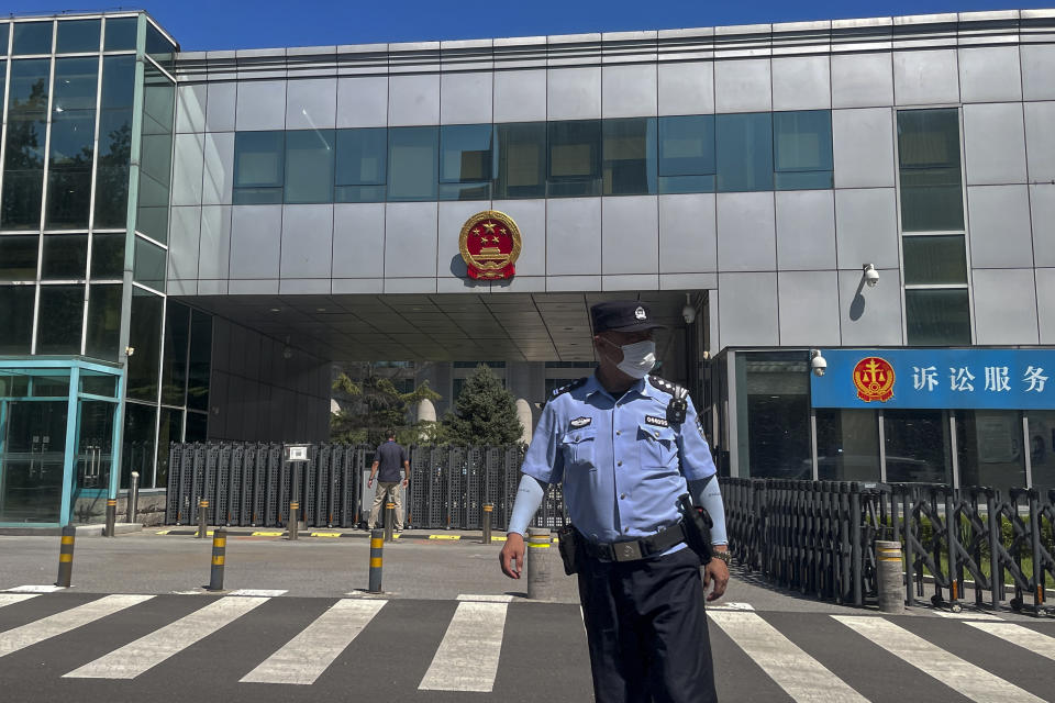 A policeman stands in front of the No. 1 Intermediate People's Court, where Zhou Xiaoxuan, a former intern at state broadcaster China Central Television, filing her appeal case against CCTV host Zhu Jun of groping and forcibly kissing her in 2014, in Beijing, Wednesday, Aug. 10, 2022. A Chinese court rejected an appeal Wednesday from a woman seeking an apology and damages in a high-profile case from the country's short-lived #MeToo movement. (AP Photo/Andy Wong)