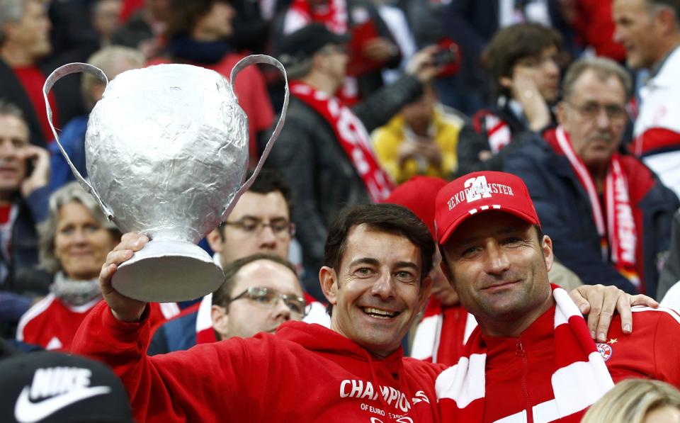 Bayern fans hold a mock-up trophy before the Champions League semi-final second leg soccer match between Bayern Munich and Real Madrid in Munich