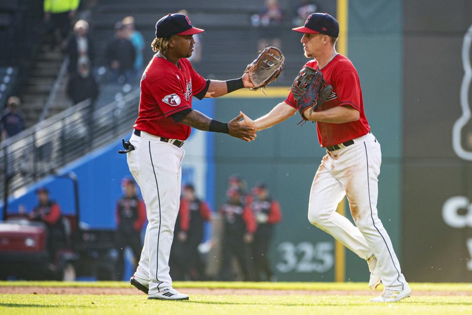 Cleveland Guardians' Jose Ramirez, left, greets Myles Straw after the team's win over the Texas Rangers in the first game of a baseball doubleheader in Cleveland, Tuesday, June 7, 2022. (AP Photo/Phil Long)