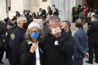 FILE - In this Oct. 5, 2020, file photo, Andrea McDonnell and her brother-in-law Kevin McDonnell leave a service honoring the 46 members of the NYPD who have died due to COVID-19 related illness at St. Patrick's Cathedral in New York. Andrea McDonnell lost her husband, Det. Christopher McDonnell, in May due to COVID-19. (AP Photo/Mark Lennihan, File)