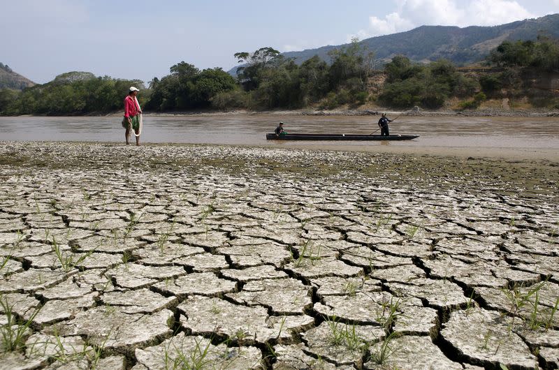 FILE PHOTO: Fisherman Gabriel Barreto stands on the shore of the Magdalena river, the longest and most important river in Colombia, in the city of Honda