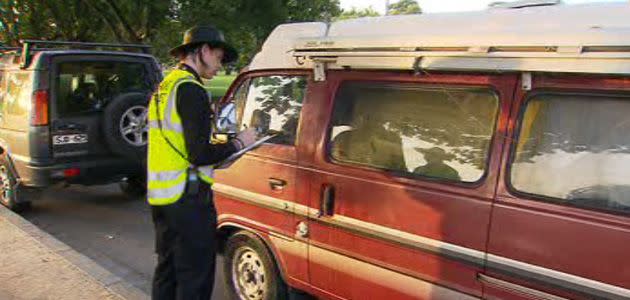 Parking inspectors swoop on the illegal camp today to warn squatters they face fines. Photo: 7News