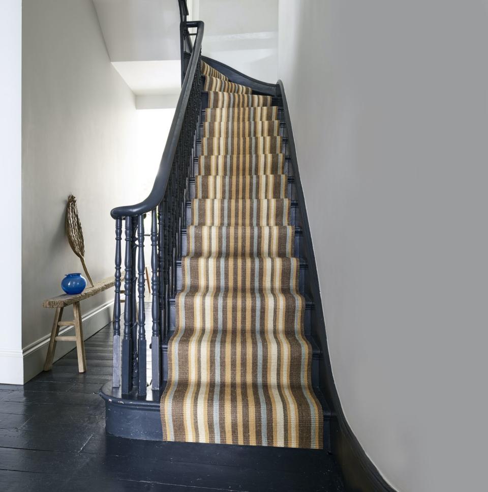 <p>With tones of brown, light blue and yellow, this stair runner from Kersaint Cobb helps to create a natural feel in the home. If you want to create a real statement, why not paint your staircase navy blue? You won't regret it. </p><p>Pictured: Kersaint Cobb, <a href="https://flooringmegastore.co.uk/morocco-runners-kersaint-cobb/" rel="nofollow noopener" target="_blank" data-ylk="slk:Morocco Runner;elm:context_link;itc:0;sec:content-canvas" class="link ">Morocco Runner</a>, Casablanca priced from £68 per linear metre.</p>