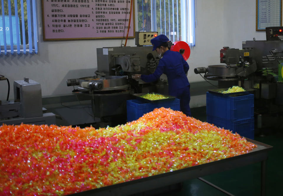 In this Oct. 22, 2018 photo, a worker monitors the production of sweets at Songdowon General Foodstuffs Factory in Wonsan, North Korea. The factory produces cookies, crackers, candies and bakery goods, plus dozens of varieties of soft drinks, that are sold all across the country. North Korean leader Kim Jong Un is waging a campaign to rally the nation behind his economic goals with on-the-spot guidance and calls for managers to step up their game. Though the international spotlight is on his nuclear talks with Washington, Kim has a lot riding domestically on making good on promises to boost the country’s economy and standard of living. And when the leader comes a calling, he has little patience for cadres lacking in “revolutionary spirit.” (AP Photo/Dita Alangkara)