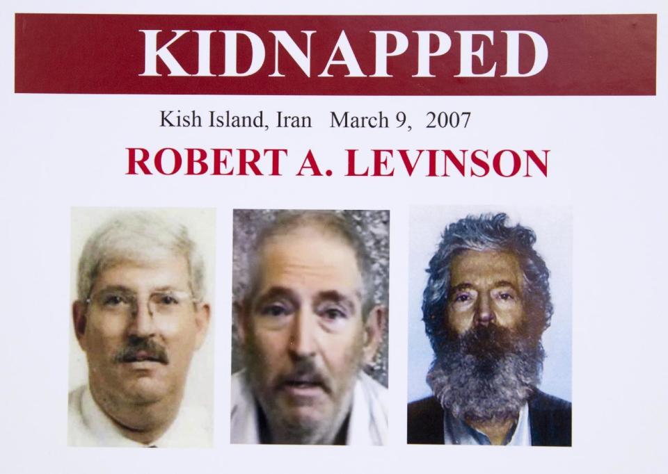 FILE- In this March 6, 2012 file photo, an FBI poster showing a composite image of former FBI agent Robert Levinson, right, of how he would look like now after five years in captivity, and an image, center, taken from the video, released by his kidnappers, and a picture before he was kidnapped, left, displayed during a news conference in Washington. It’s been 10 years since former FBI agent Robert Levinson disappeared while in Iran on an unauthorized CIA mission and his family is still waiting for answers. His family tells The Associated Press they hope the new administration of President Donald Trump will do more to find him. (AP Photo/Manuel Balce Ceneta, File)