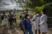 People wait to be vaccinated with the Cuban Abdala vaccine for COVID-19 outside a doctors' office in Alamar on the outskirts of Havana, Cuba, Friday, May 14, 2021. Cuba has begun to immunize people this week with its own vaccines, Abdala and Soberana 02, the only ones developed by a Latin American country. (AP Photo/Ramon Espinosa)