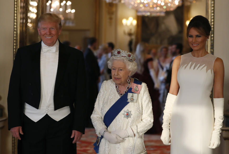 (left to right) US President Donald Trump, Queen Elizabeth II and Melania Trump, during a group photo ahead of the State Banquet at Buckingham Palace, London, on day one of US President Donald Trump's three day state visit to the UK.