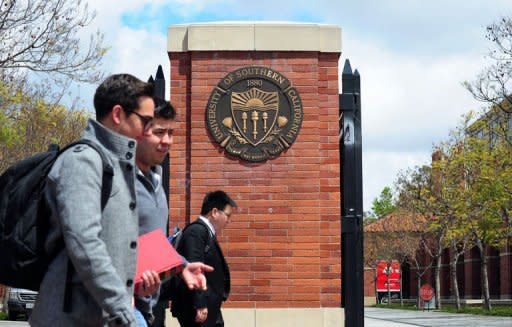 Students walk past an entrance to the University of Southern California (USC) in Los Angeles on April 11, 2012 in California. Two Chinese graduate students from the university were killed in an overnight shooting, which police suspect could have been a failed carjacking in an area southwest of downtown Los Angeles