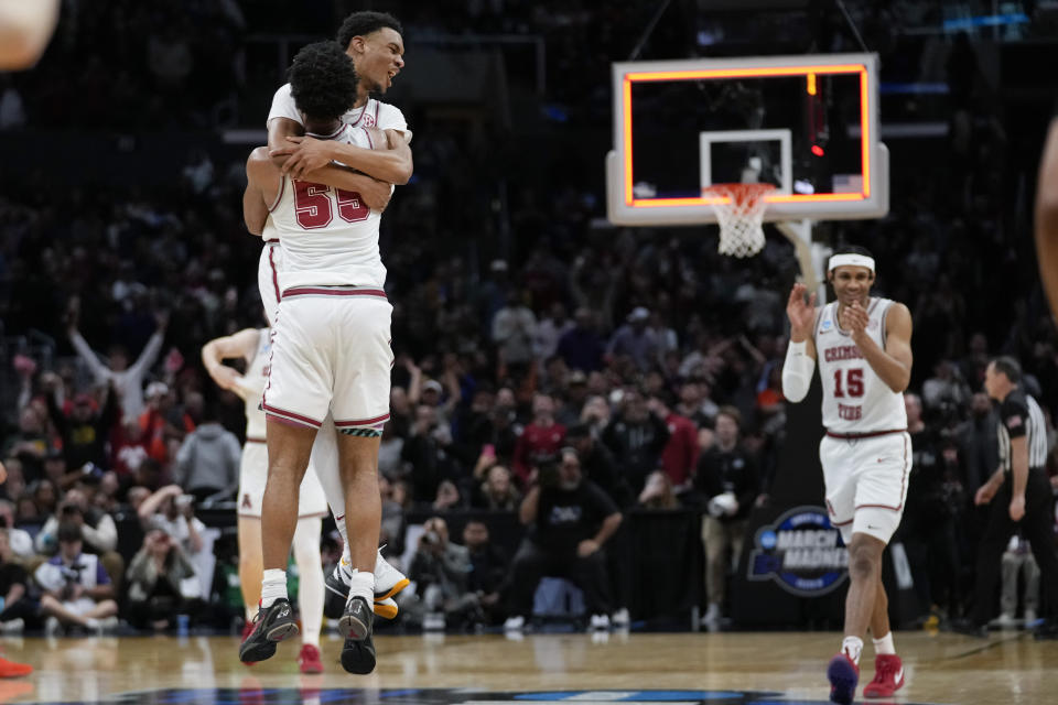 Alabama guard Rylan Griffen, facing camera at left, celebrates with guard Aaron Estrada (55) after a win over Clemson in an Elite 8 college basketball game in the NCAA tournament Saturday, March 30, 2024, in Los Angeles. (AP Photo/Ashley Landis)