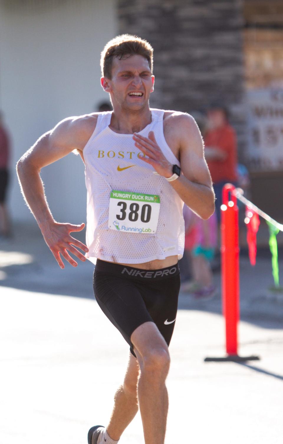 Sam Parlette of White Lake finishes first overall in the Hungry Duck Run half marathon Monday, July 4, 2022.