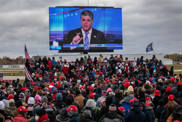 Trump supporters watch Sean Hannity speak ahead of Trump's arrival at a campaign rally in Waterford, Michigan, last year. (Photo: John Moore via Getty Images)