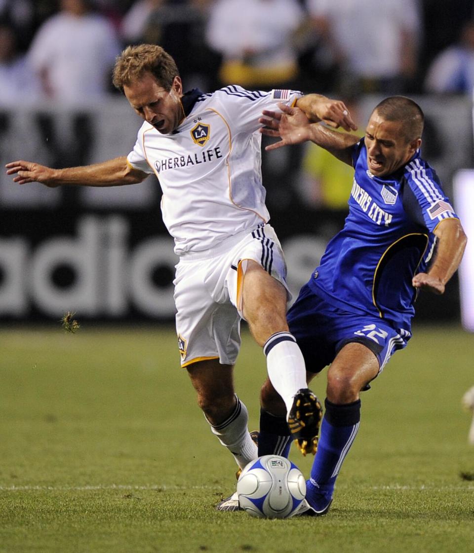 Galaxy midfielder Eddie Lewis, left, battles Kansas City's Davy Arnaud for the ball