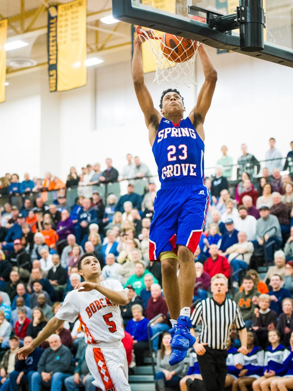 Spring Grove's Eli Brooks (23) completes a slam dunk on a fast break against Northeastern's Donovian Maxfield (5) in a YAIAA boys basketball semifinal game at Red Lion Area High School on Thursday, Feb. 11, 2016. Spring Grove won 59-57.