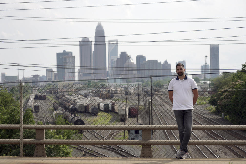 Fernando Hermida stands for a portrait against the skyline of Charlotte, N.C., on May 26, 2024. (AP Photo/Laura Bargfeld)