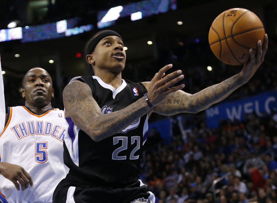 Sacramento Kings guard Isaiah Thomas (22) shoots in front of Oklahoma City Thunder center Kendrick Perkins (5) in the second quarter of an NBA basketball game in Oklahoma City, Sunday, Jan. 19, 2014. (AP Photo/Sue Ogrocki)