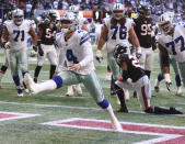 Dallas Cowboys quarterback Dak Prescott reacts to scoring a touchdown on a quarterback keeper past Atlanta Falcons safety Damontae Kazee during the fourth quarter of an NFL football game Sunday, Nov. 18, 2018, in Atlanta. Dallas won 22-19. (Curtis Compton/Atlanta Journal-Constitution via AP)