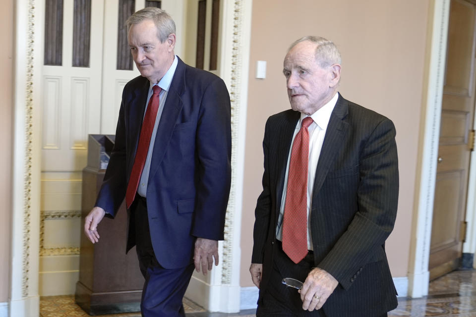 Sen. Mike Crapo, R-Idaho, left and Sen. Jim Risch, R-Idaho, right, walks through the U.S. Capitol Wednesday, Feb. 7, 2024, in Washington. (AP Photo/Mariam Zuhaib)