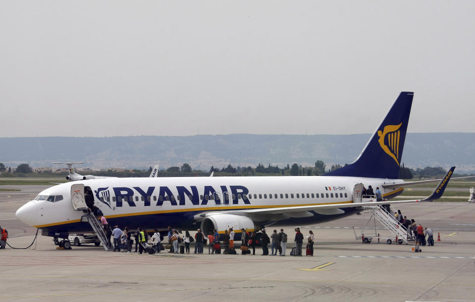 FILE - In this Wednesday, May 13, 2015 file photo passengers disembark a Ryanair plane, at the Marseille Provence airport, in Marignane, southern France. German Ryanair pilots will go on a 24-hours strike on Friday, Aug. 10, 2018 in Germany. (AP Photo/Claude Paris, File)