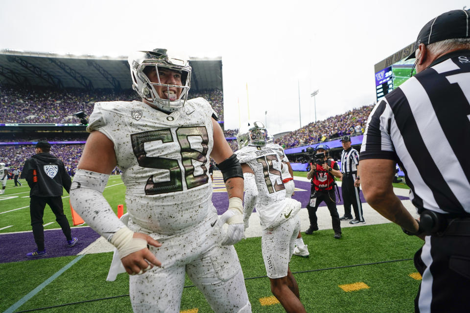 FILE - Oregon offensive lineman Jackson Powers-Johnson reacts after wide receiver Tez Johnson (15) made a two point conversion catch against Washington during the second half of an NCAA college football game, Saturday, Oct. 14, 2023, in Seattle. Powers-Johnson has been selected to The Associated Press midseason All-America team, Wednesday, Oct. 18, 2023.(AP Photo/Lindsey Wasson, File)