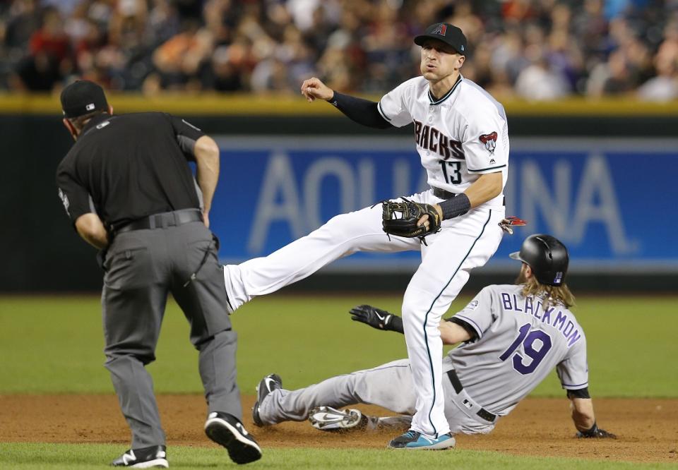 D-backs shortstop Nick Ahmed follows through after Charlie Blackmon’s questionable slide at second base. (AP)