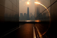 <p>The One World Trade Center tower in lower Manhattan in New York City is pictured from the Empty Sky 911 Memorial in Jersey City, New Jersey, shortly after sunrise as haze and smoke caused by wildfires in Canada hangs over the Manhattan skyline in New York, U.S., June 8, 2023. REUTERS/Mike Segar</p> 