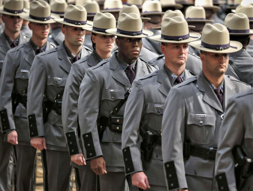 New state troopers stand during the 201st graduation ceremony of the New York State Police at Empire State Plaza Convention Center in Albany.