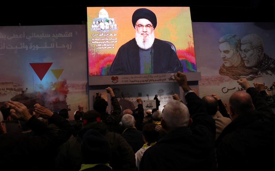 People watch a televised speech of Lebanon's Hezbollah chief Hassan Nasrallah to mark the anniversary of the death of Qassim Soleimani