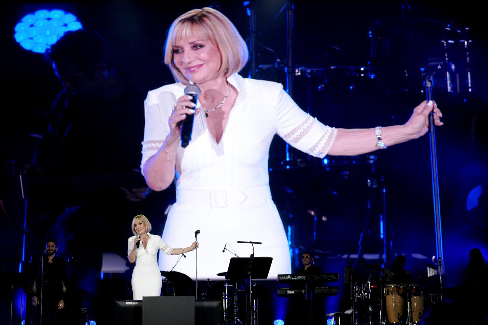 Iranian pop star Googoosh performs during a concert at the Dubai Expo 2020, in Dubai, United Arab Emirates, Thursday, March 17, 2022. Iranian pop diva and national icon Googoosh delivered old hits and songs from her new album to a packed stadium on Thursday in Dubai — just across the Persian Gulf from her home that had banned her from singing for 21 years and where authorities to this day continue to protest her performances. (AP Photo/Ebrahim Noroozi)