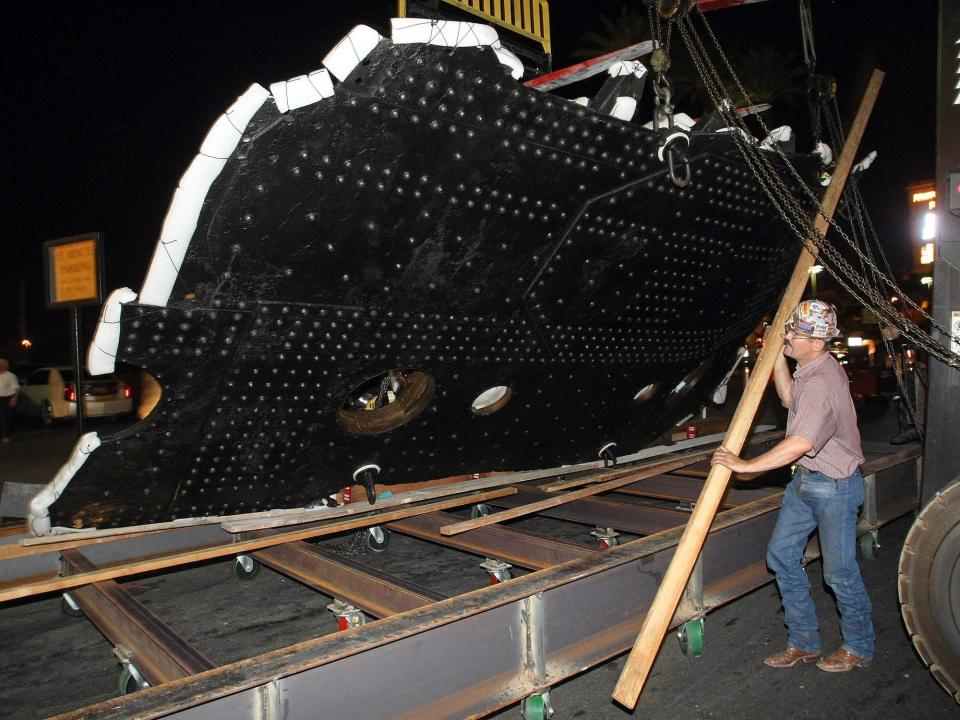 An ironworker moves the big piece of the Titanic into the Luxor Resort & Casino.