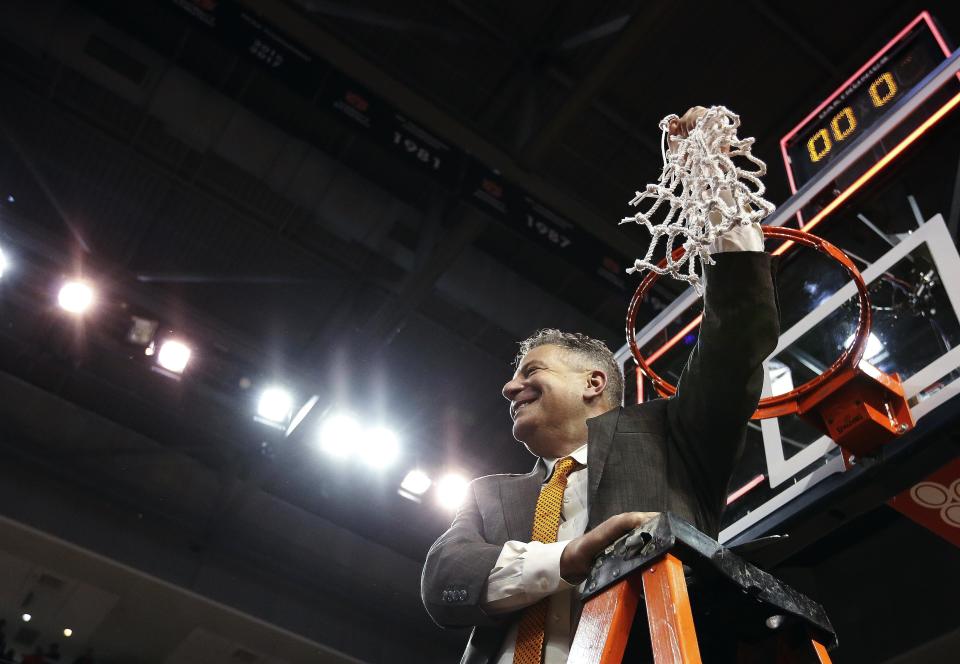 Auburn head coach Bruce Pearl cuts down the net after an NCAA college basketball game against South Carolina, Saturday, March 3, 2018, in Auburn, Ala. (AP Photo/Brynn Anderson)