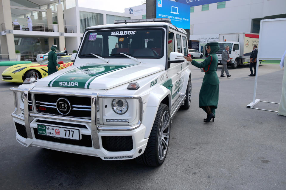 DUBAI, UNITED ARAB EMIRATES – NOVEMBER 18: A Female Emerati police officer locks her Mercedes Benz Brabus 4×4 supercar during the Dubai Airshow on November 18, 2013 in Dubai, United Arab Emirates.