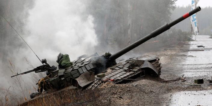 A Russian tank destroyed by Ukrainian fighters lies at the side of the road in the Lugansk region of Ukraine.