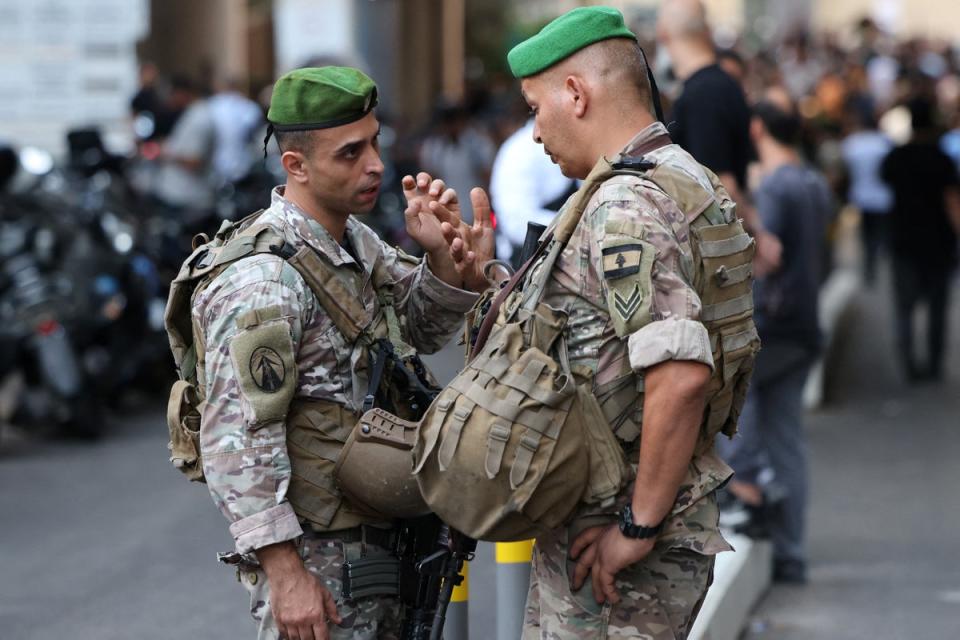 Lebanese army soldiers stand guard at the entrance of a hospital (background) in Beirut (AFP via Getty Images)