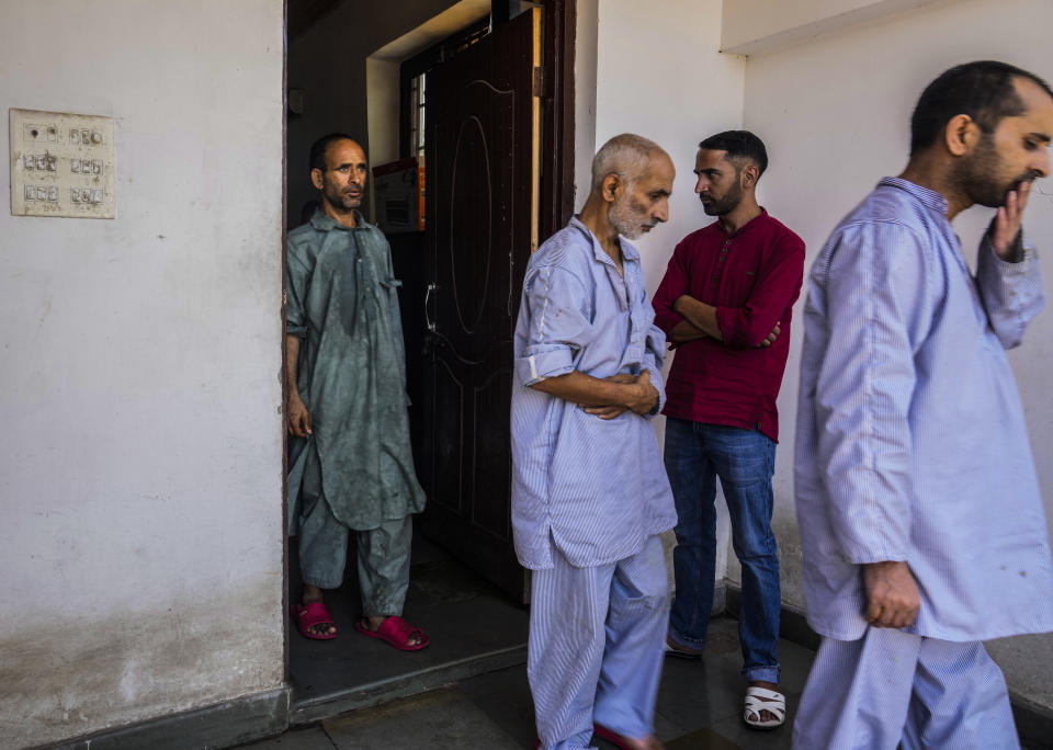 Patients walk at a mental health hospital in Srinagar, Indian controlled Kashmir, Tuesday, Aug 1, 2023. Kashmir's mental healthcare clinics depict invisible scars of decades of violent armed insurrections, brutal counterinsurgency, unparalleled militarization, unfulfilled demands for self-determination have fueled depression and drugs in the disputed region, experts say. (AP Photo/Mukhtar Khan)