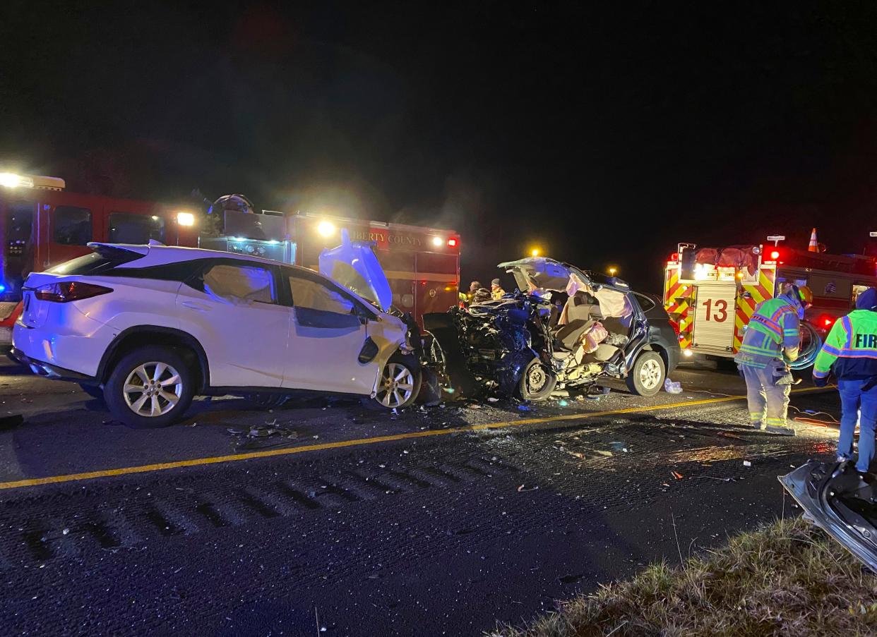 First responders from the Midway Fire Department survey the scene of a fatal accident on Interstate 95, which claimed the lives of multiple people, early Sunday morning, Feb. 23, 2020, in Liberty County, Ga. (AP Photo/Lewis Levine)