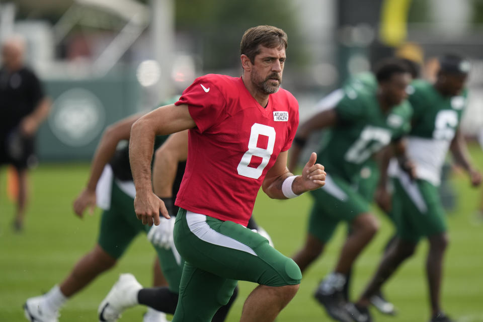 New York Jets quarterback Aaron Rodgers warms-up during a joint NFL football practice with the Tampa Bay Buccaneers, Wednesday, Aug. 16, 2023, in Florham Park, N.J. (AP Photo/Seth Wenig)