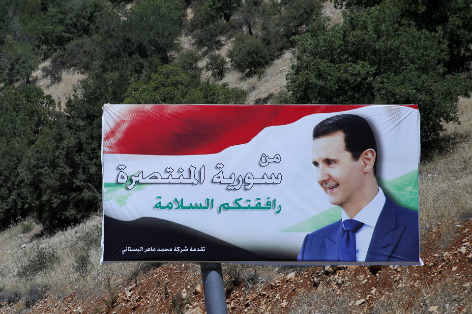 FILE - In this July 20, 2018 file photo, a poster of Syrian President Bashar Assad with Arabic that reads "Welcome in victorious Syria," is displayed on the border between Lebanon and Syria. Assad told a little-known Kuwaiti newspaper that Syria has reached a “major understanding” with other Arab states after years of hostility over the country’s civil war. The interview published Wednesday, Oct. 3, 2018, in the Al-Shahed newspaper, was Assad's first with a Gulf newspaper since the war began in 2011. (AP Photo/Hassan Ammar, File)