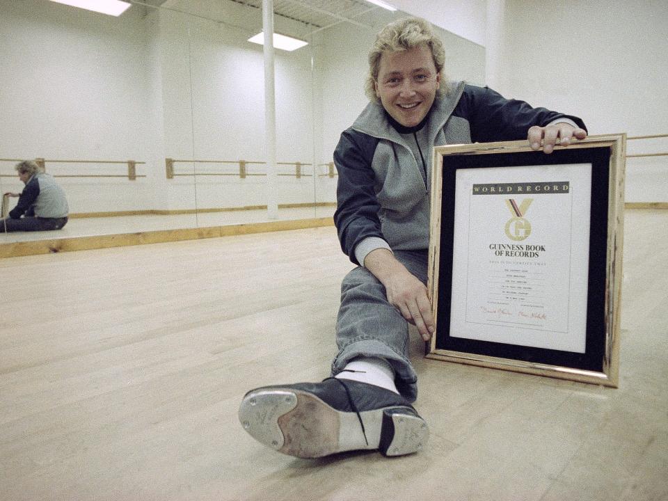 A dancer sits with his world record in a studio in Illinois in 1989.