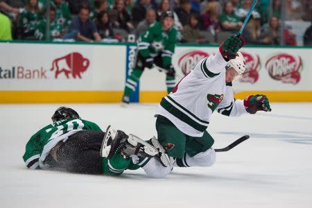 Apr 22, 2016; Dallas, TX, USA; Dallas Stars center Cody Eakin (20) trips up Minnesota Wild center Mikael Granlund (64) during the first period in game five of the first round of the 2016 Stanley Cup Playoffs at the American Airlines Center. Mandatory Credit: Jerome Miron-USA TODAY Sports