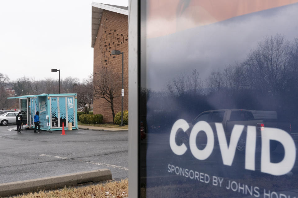 In this Thursday, Feb. 11, 2021, photo people arrive for COVID-19 vaccinations at a clinic outside the Pennsylvania Avenue Baptist Church, Thursday, Feb. 11, 2021, in southeast Washington. (AP Photo/Jacquelyn Martin)