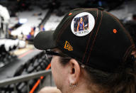 Phoenix Mercury fan Anna Oyerbides wears a "#FreeBG" button referring to Brittney Griner before a WNBA basketball game between the Mercury and the Las Vegas Aces, Friday, May 6, 2022, in Phoenix. Griner has been detained in Russia since Feb. 17 after authorities at the Moscow airport said they found vape cartridges that allegedly contained oil derived from cannabis in her luggage. (AP Photo/Darryl Webb)